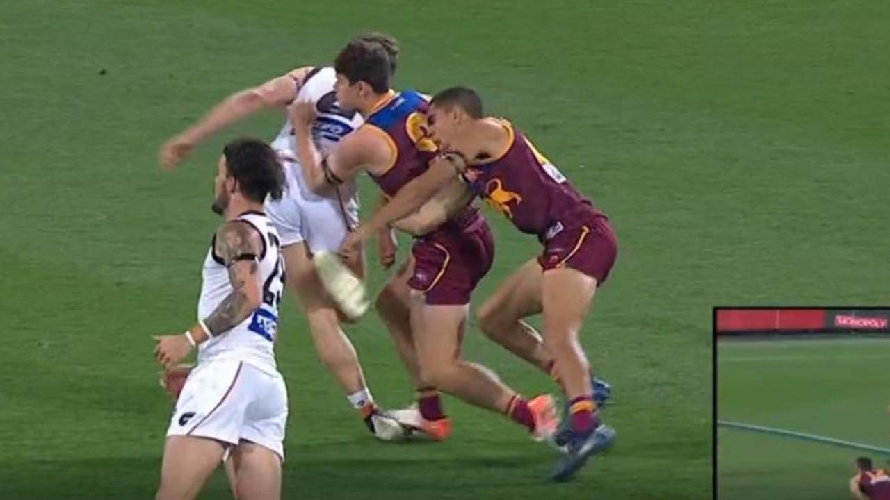 Brisbane's Charlie Cameron gets his arm caught in between two players.