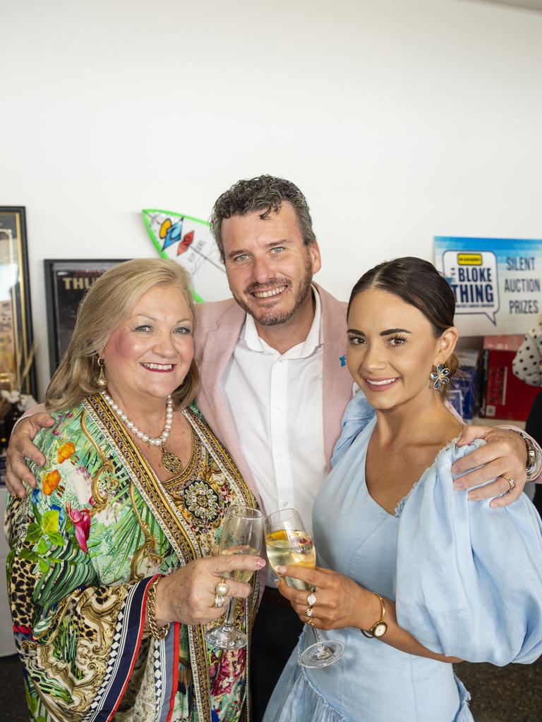 Checking out the silent auction prizes are (from left) Rowena Hogan, Clayton Menyweather and Kate Ruijter at It's a Bloke Thing 2022 at Wellcamp Airport, Friday, September 9, 2022. Picture: Kevin Farmer