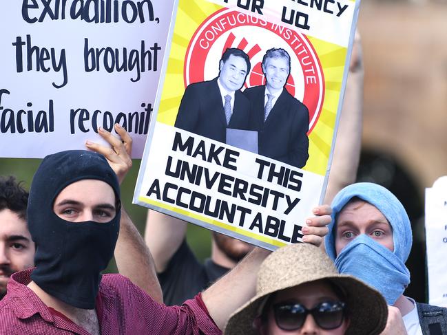 Students hold placards during a protest at the University of Queensland. Picture: AAP