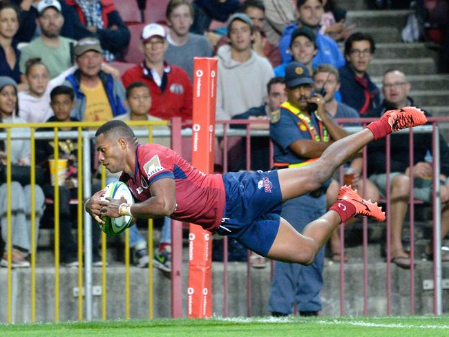 Reds wing Filipo Daugunu dives over to score a try.