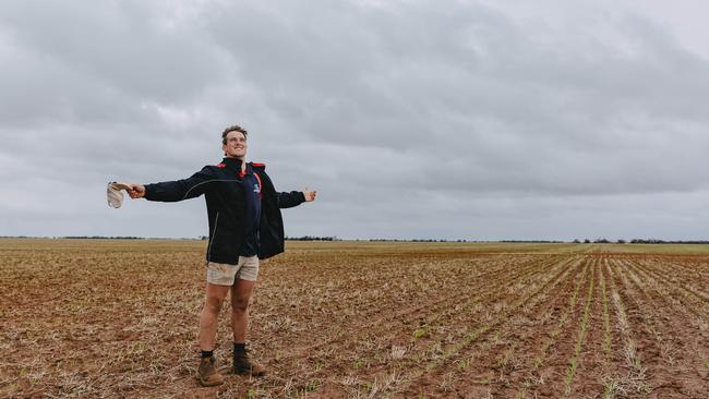 Wet underfoot: Bill Lee celebrates the rainfall that will give crops the best start at his family farm at Birchip. Picture: CHLOE SMITH