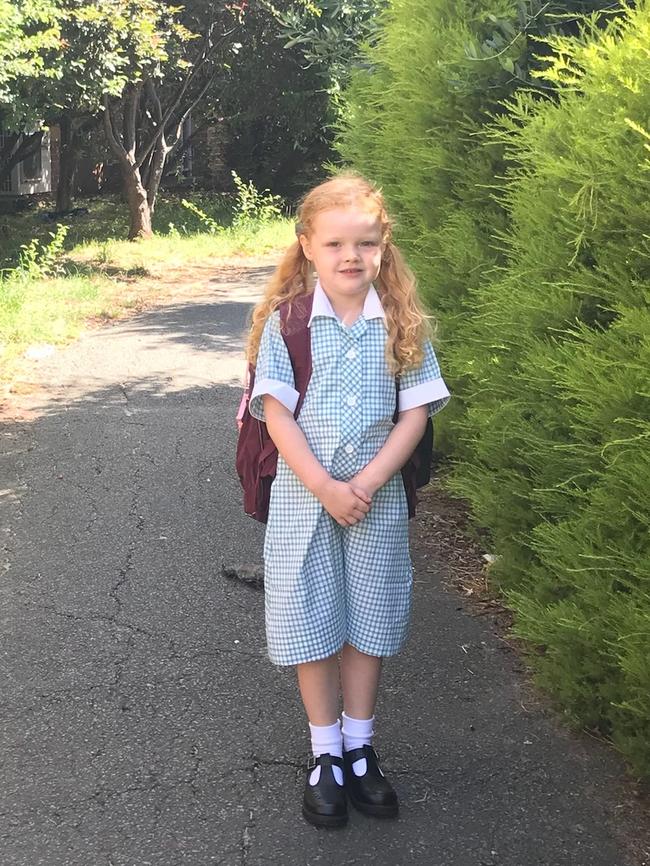 Tilly Young, 5, stands in the same spot as her mum two decades later as she prepares to start at the same school. Picture: Supplied