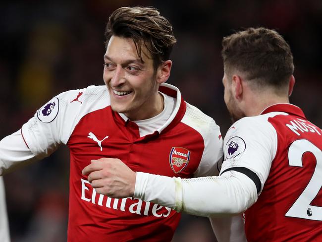 LONDON, ENGLAND - NOVEMBER 29: Mesut Ozil of Arsenal celebrates after scoring his sides fourth goal with Shkodran Mustafi of Arsenal during the Premier League match between Arsenal and Huddersfield Town at Emirates Stadium on November 29, 2017 in London, England.  (Photo by Julian Finney/Getty Images)