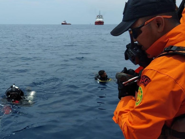 Divers  search for the plane wreckage after the tragic crash.