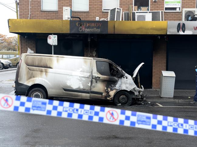 Police at the scene where a van was torched in Glenroy. Picture: Andrew Henshaw