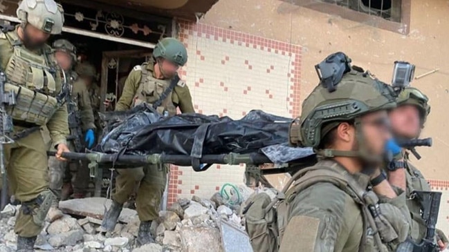 IDF soldiers carry the body of Hamas leader Yahya Sinwar on stretcher en route to Israel from Gaza.