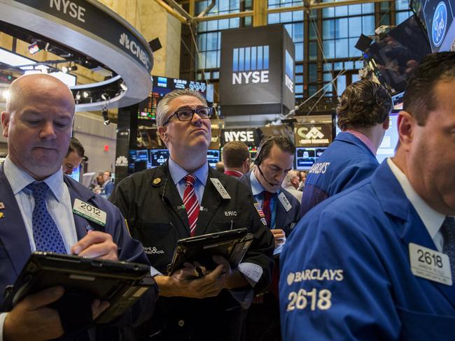 Traders work on the floor of the New York Stock Exchange shortly after the opening of the markets in New York October 22, 2015. REUTERS/Lucas Jackson
