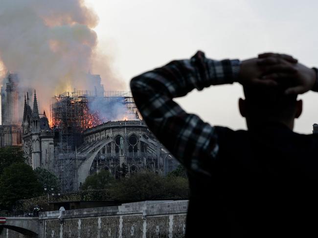 People watched in horror as firefighters tackled the blaze, with smoke seen across Paris. Picture: AFP