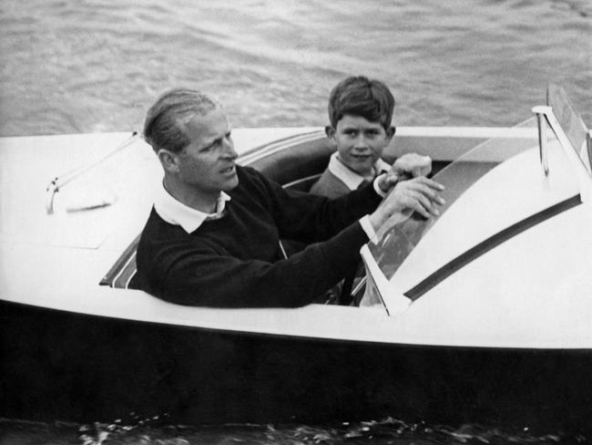 (FILE PIC)  Undated picture showing Prince Charles of Wales with his father Prince Philip of Edinburgh on board a boat. (Photo by - / AFP)