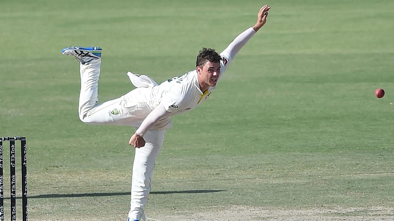 Mitchell Swepson (R) delivers the ball during the fourth day of the second Test cricket match between Pakistan and Australia at the National Cricket Stadium in Karachi on March 15, 2022. (Photo by Rizwan TABASSUM / AFP)