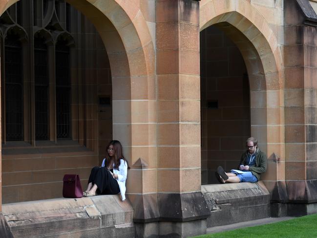 Students read at the Quadrangle of the University of Sydney in Sydney on Tuesday, May 2, 2017. The government has revamped its controversial 2014 budget package of changes by dumping plans for deregulated course fees and a 20 per cent cut in funding for universities. (AAP Image/Paul Miller) NO ARCHIVING