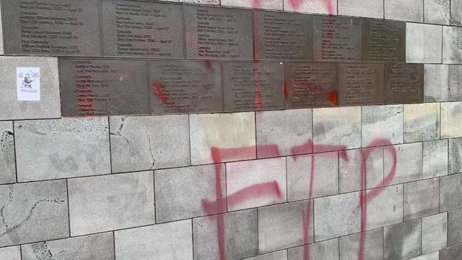 Vile graffiti has been spray painted across the St Kilda Road police memorial. Picture: ABC News, Tania Lee