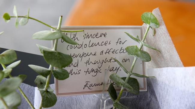 Flowers left in a memorial outside the cafe. Picture: Toby Zerna