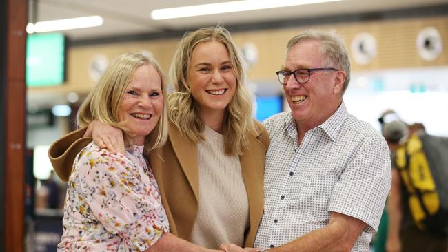 Amanda Osuchowski is reunited with her parents Kerry and Peter Stallard after arriving on the first flight from Melbourne at Hobart airport after the borders reopened to Victoria today. Picture: Zak Simmonds