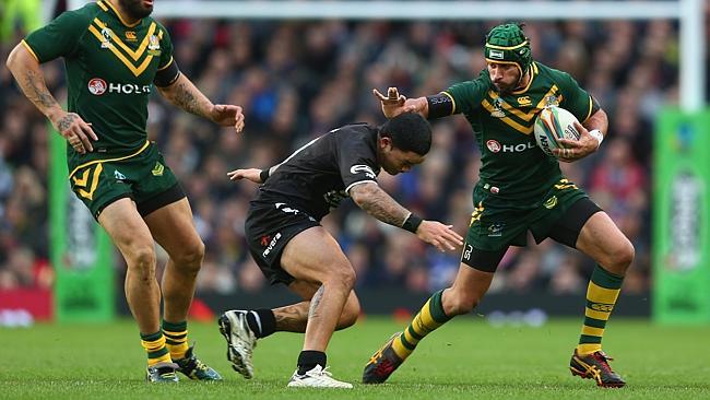 Johnathan Thurston keeps Issac Luke of New Zealand at arms length during the Rugby League World Cup Final.