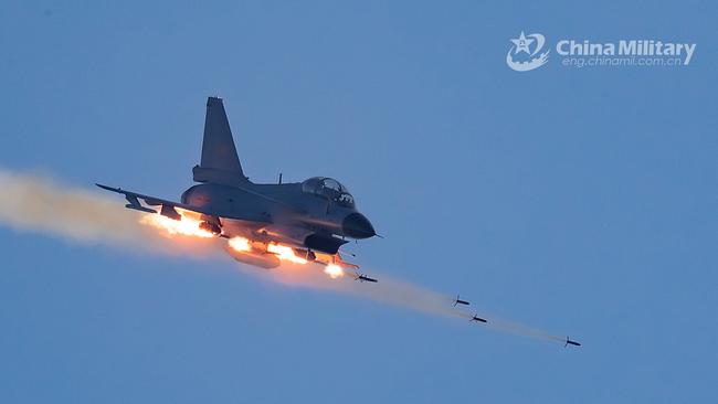 A People’s Liberation Army handout image of a Chinese J-10 fighter jet firing rockets at mock ground targets. Picture: PLA