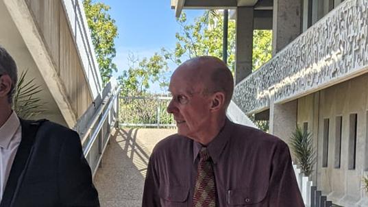 John Starmer (right) walks from Townsville Courthouse after an earlier appearance.