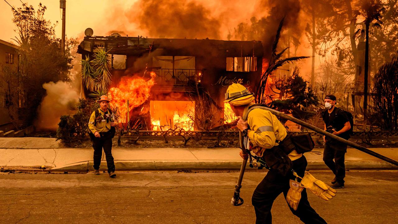 Firefighters work the scene as an apartment building burns during the Eaton fire in the Altadena area. Picture: Josh Edelson/AFP