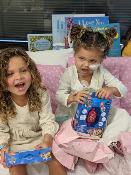 Unwrapping their birthday gifts. Photo: Supplied