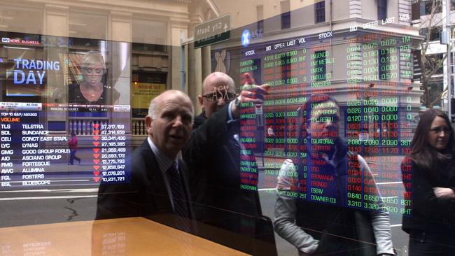 Investors look at stocks on electronic stock boards at the Australia Securities Exchange headquarters in Sydney. Picture: Bloomberg