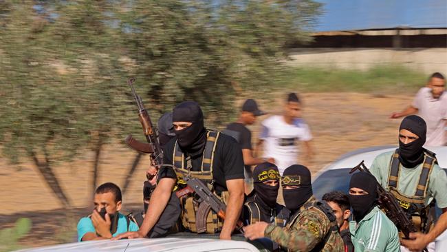 Palestinian militants move towards the border fence with Israel from Khan Yunis in the southern Gaza Strip. Picture: AFP