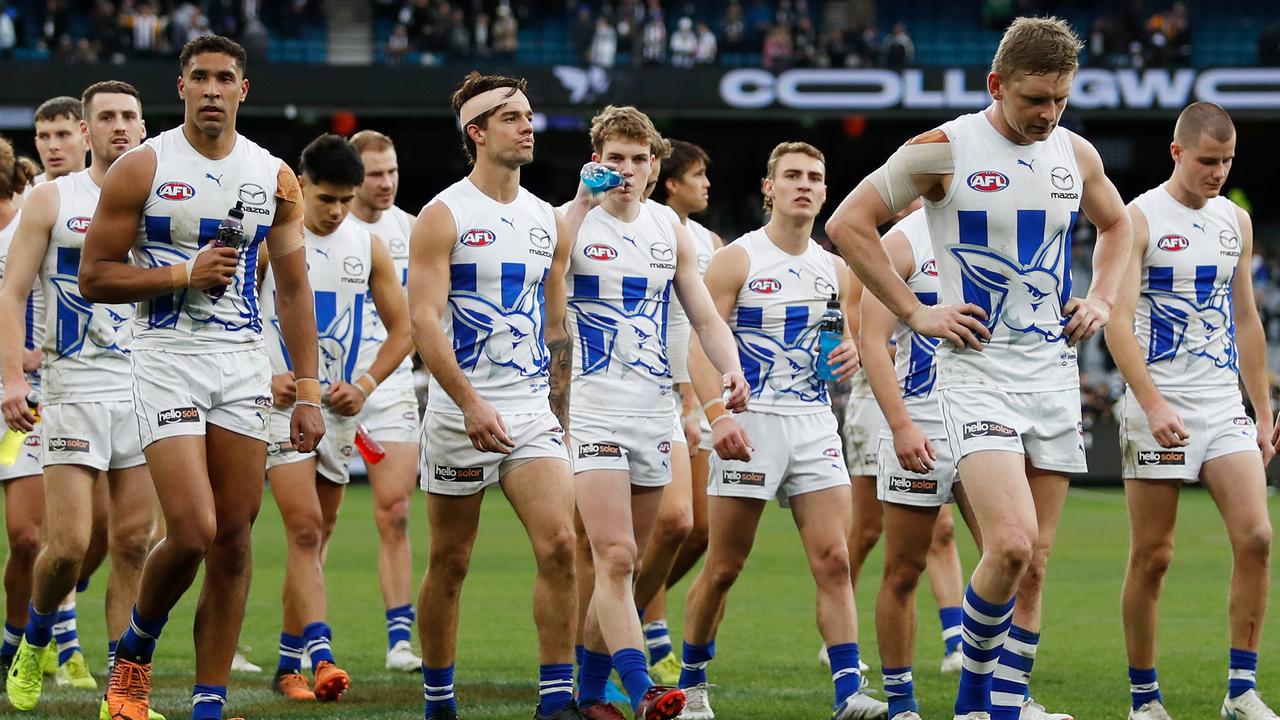 MELBOURNE, AUSTRALIA - JULY 09: North Melbourne leave the field looking dejected during the 2022 AFL Round 17 match between the Collingwood Magpies and the North Melbourne Kangaroos at the Melbourne Cricket Ground on July 09, 2022 in Melbourne, Australia. (Photo by Dylan Burns/AFL Photos via Getty Images)