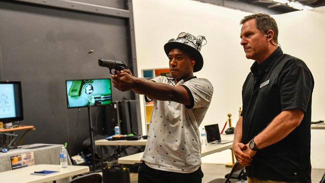 Film and TV armourer and prop master Dutch Merrick (R) demonstrates how to use a gun safely. Picture: AFP