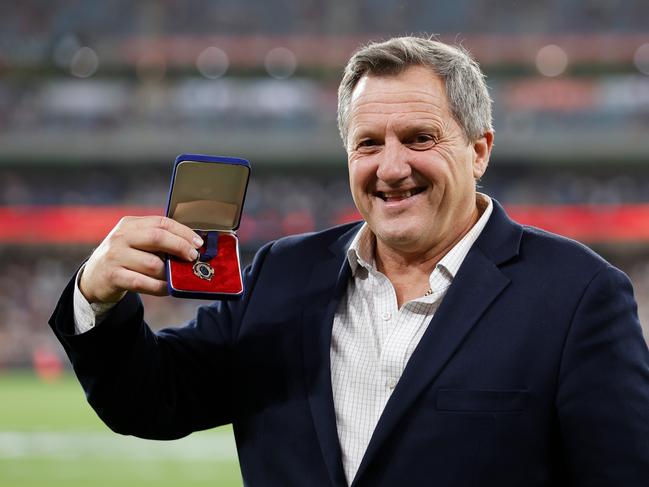 MELBOURNE, AUSTRALIA - MARCH 18: Brian Wilson, former Melbourne Demons player and Brownlow Medal winner in 1982 poses for a photo with his Brownlow Medal after he lost it many years ago during the 2023 AFL Round 01 match between the Melbourne Demons and the Western Bulldogs at the Melbourne Cricket Ground on March 18, 2023 In Melbourne, Australia. (Photo by Dylan Burns/AFL Photos via Getty Images)