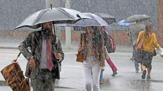 Commuters near Sydney’s Central Station battle wild, wet and windy weather on Thursday. Picture: NCA NewsWire / Nicholas Eagar