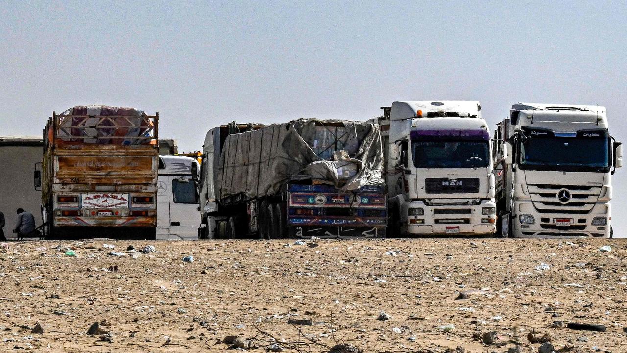 Egyptian trucks carrying humanitarian aid bound for the Gaza Strip wait near the Rafah border crossing. Hamas says ground aid is the only way. Picture: AFP