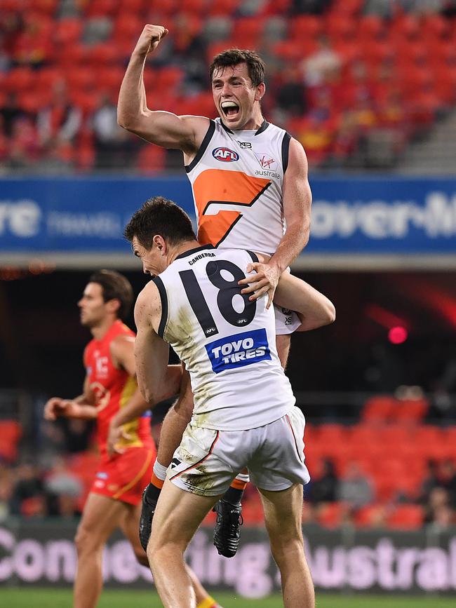 Jeremy Cameron lifts teammate Brent Daniels after his seventh goal, which took him ahead of Ben Brown. Picture: AAP Image/Dave Hunt.