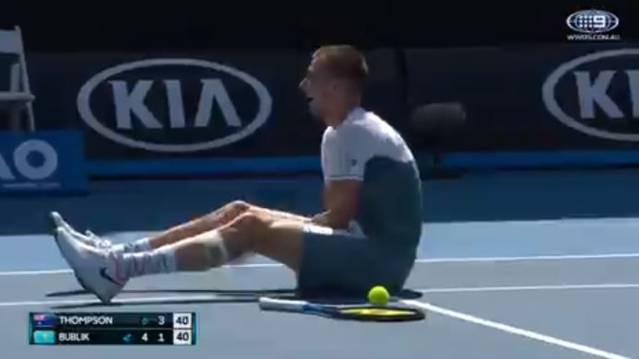 Alexander Bublik sits on the court laughing at the chair umpire after a particularly bad call that he successfully reviewed against Jordan Thompson.