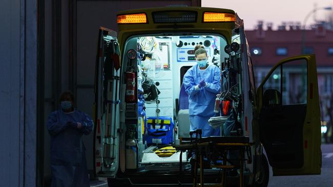 A paramedic disinfects her hands after transporting a patient to Burgos General Hospital in northern Spain. Picture: AFP