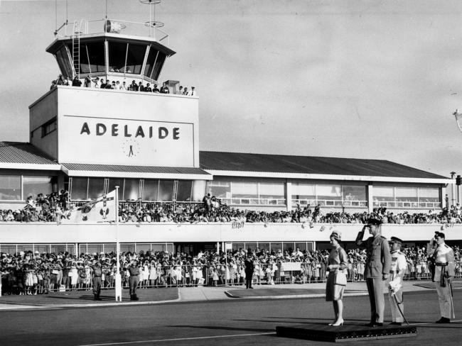 Queen Elizabeth II with Prince Philip Duke standing on dais for the playing of the national anthem at Adelaide Airport.