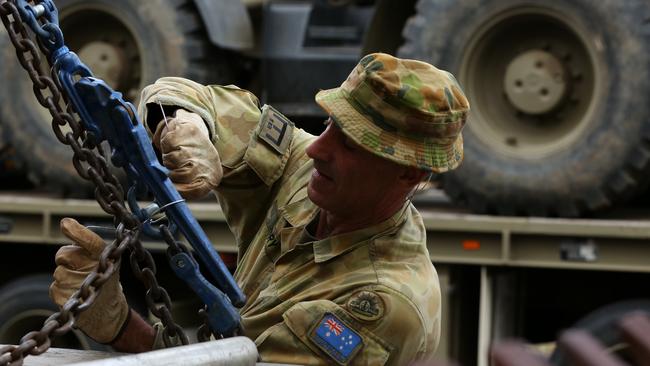 Corporal Justin Perry 4th Squadron 5ER fastens a vehicle to a truck at Holsworthy Barracks on Sunday. Picture: AAP/Danny Casey