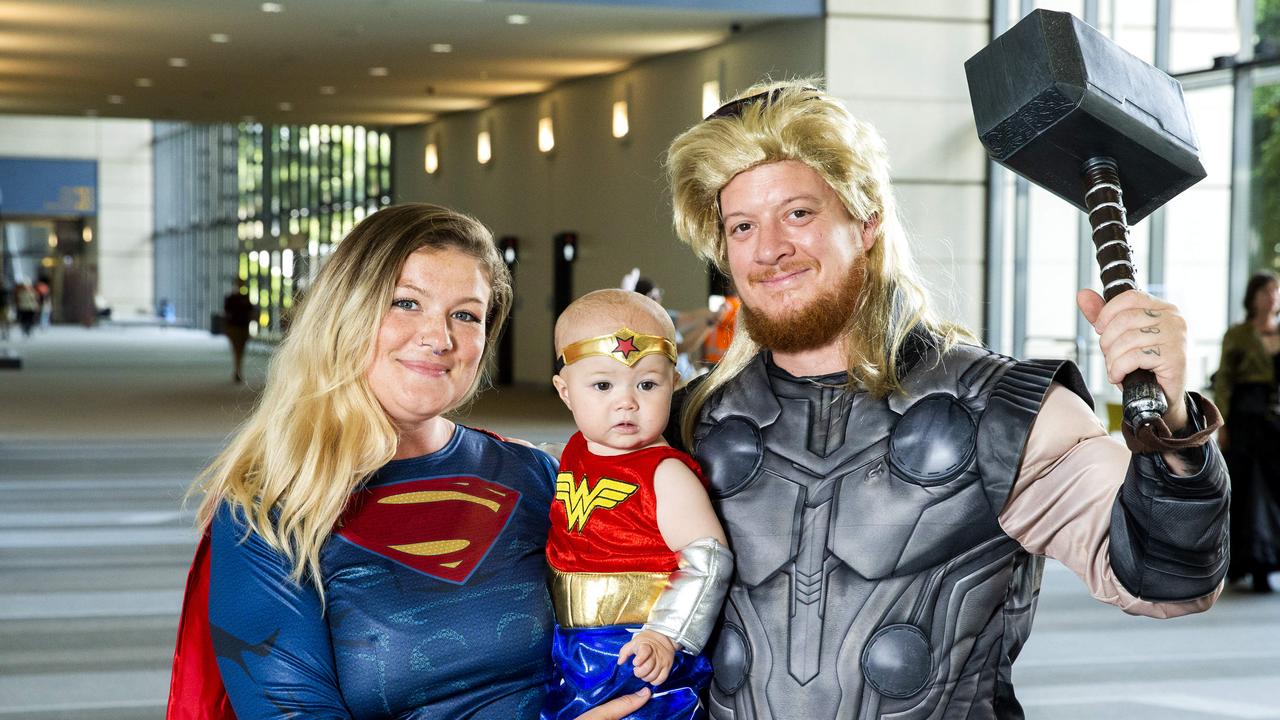 Tomi Restorick with 10-month-old Hazel and Ben Jell from Sunshine Coast pose for a photograph at 2019 Oz Comic-Con in Brisbane, Sunday, September 22, 2019 (AAP Image/Richard Walker)