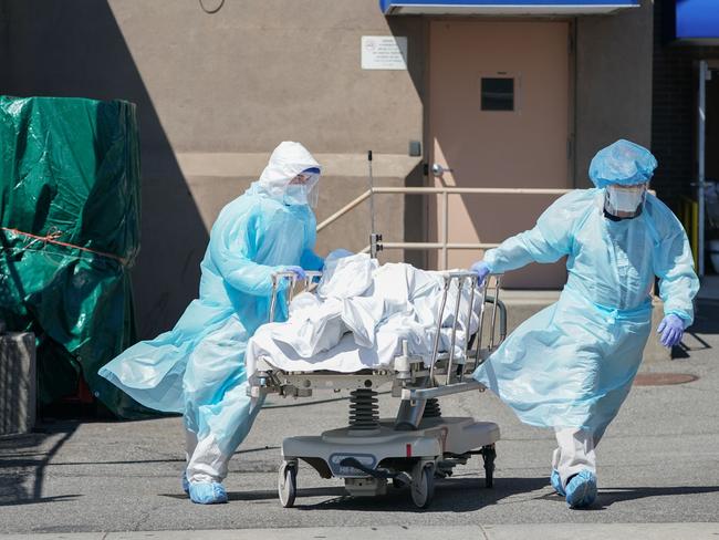 Bodies are moved to a refrigeration truck in New York. Picture: AFP.