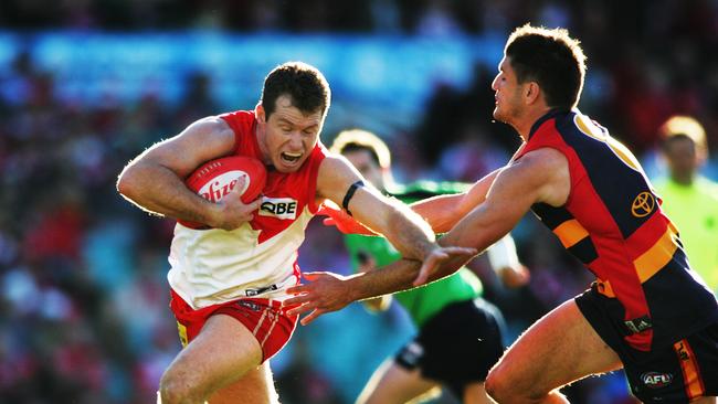 Paul Williams breaks tackle of Adelaide’s Nathan Bassett at SCG in Sydney.