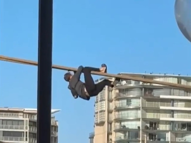 Emergency services were called to The Rocks about 3pm on Saturday, following reports a man had attempted to climb onto the cruise ship via a mooring rope. Image: 9 News