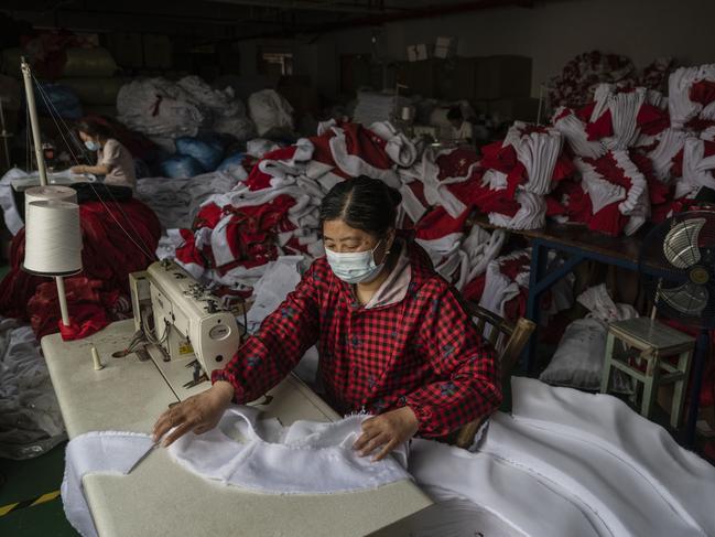 YIWU, CHINA - APRIL 28: A worker sews fabric to be used in Christmas decorations for export at a factory on April 28, 2025 near Yiwu, Zhejiang Province, China. The Yiwu area is home to thousands of China's small commodities companies, many of which in recent years due to trade tensions with the United States have looked to the Middle East, Africa and South America for new business. After President Trump put tariffs as high as 145 percent on Chinese goods, many producers saw orders from American clients cancelled or at least temporarily put on hold. (Photo by Kevin Frayer/Getty Images)