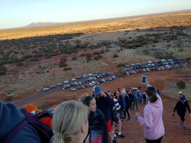 This handout photo taken on September 25, 2019 and received on October 10 courtesy of @koki_mel_aus on Instagram shows tourists climbing Uluru in Australia's Northern Territory. - Large numbers of tourists are rushing to scale Uluru -- also known as Ayers Rock -- ahead of a looming ban on climbing a site sacred to indigenous Australians. (Photo by Handout / @koki_mel_aus. / AFP) / -----EDITORS NOTE --- RESTRICTED TO EDITORIAL USE - MANDATORY CREDIT "AFP PHOTO / @KOKI_MEL_AUS" - NO MARKETING - NO ADVERTISING CAMPAIGNS - DISTRIBUTED AS A SERVICE TO CLIENTS - NO ARCHIVES