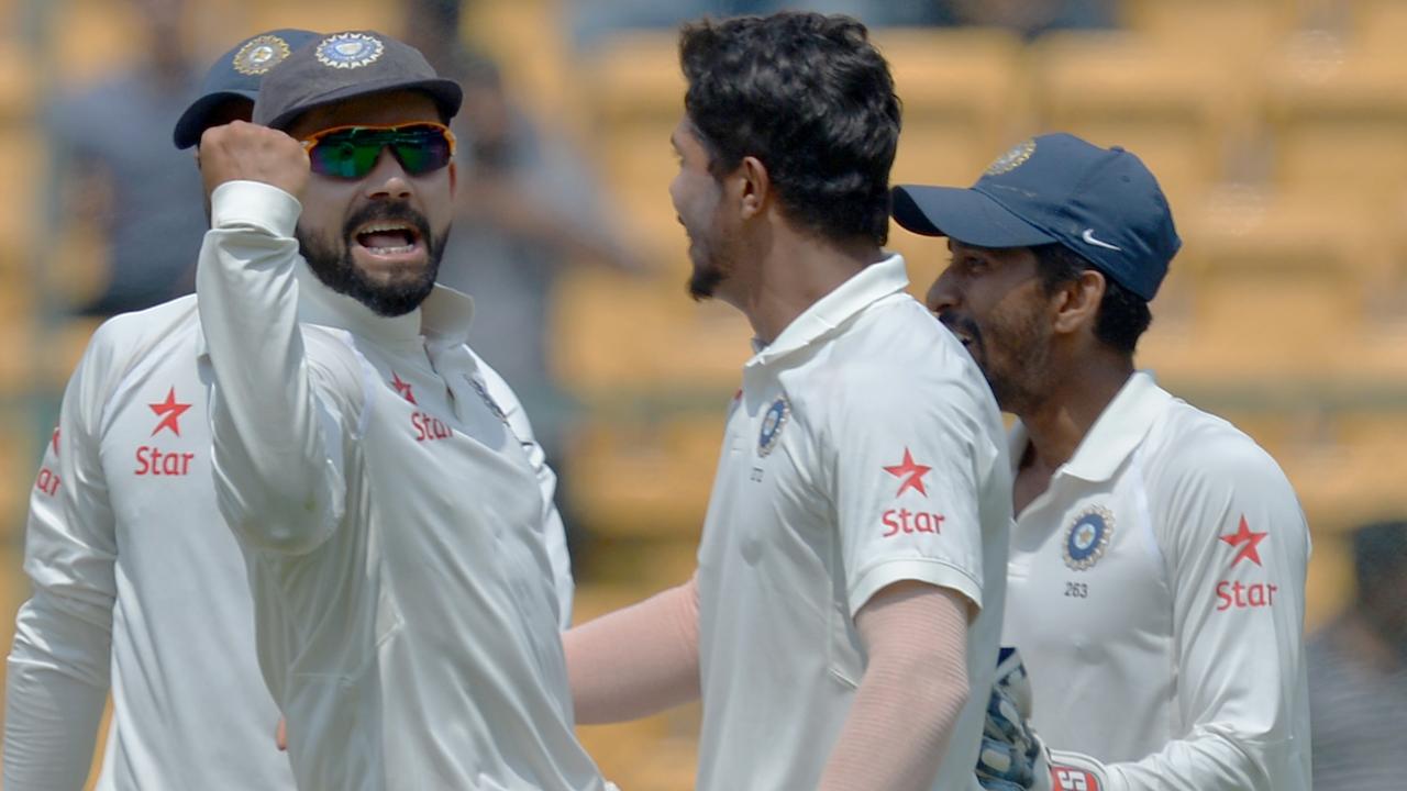 Indian bowler Umesh Yadav (2R) celebrates with captain Virat Kohli (C) and his teammates, the dismissal of Australian captain Steve Smith during the 2017 Teeries in India. Picture:AFP PHOTO