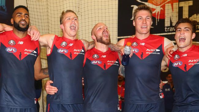 MELBOURNE, AUSTRALIA - APRIL 24: Heritier Lumumba, James Harmes, Nathan Jones, Tom McDonald and Jack Viney of the Demons sing the song in the rooms after winning the round five AFL match between the Melbourne Demons and the Richmond Tigers at Melbourne Cricket Ground on April 24, 2016 in Melbourne, Australia. (Photo by Quinn Rooney/Getty Images)