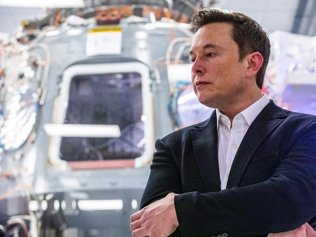 SpaceX founder Elon Musk addresses members of the media during a press conference announcing new developments of the Crew Dragon reusable spacecraft, at SpaceX headquarters in Hawthorne, California. (Photo by Philip Pacheco / AFP)