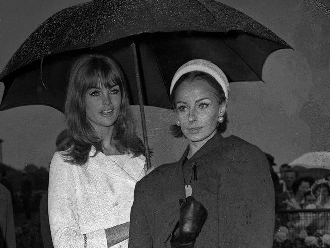 Jean Shrimpton shares an umbrella with fellow model Christine Borge on Oaks Day in 1965. Picture: Al Pascoe