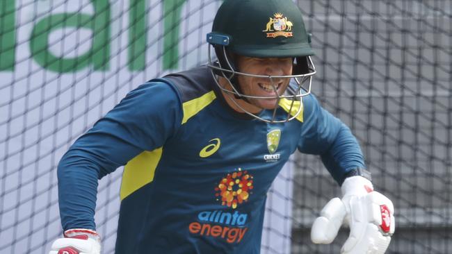 David Warner winces after being struck on the hand at Australian training.