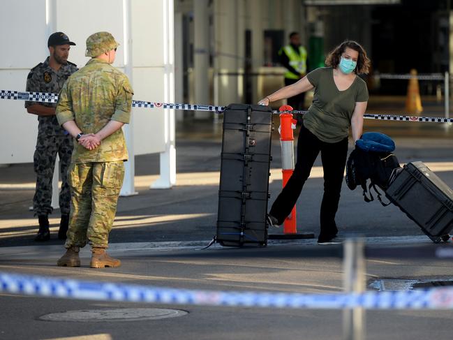 New arrivals at Sydney International airport are ushered into waiting buses for hotel quarantine. Picture: Jeremy Piper