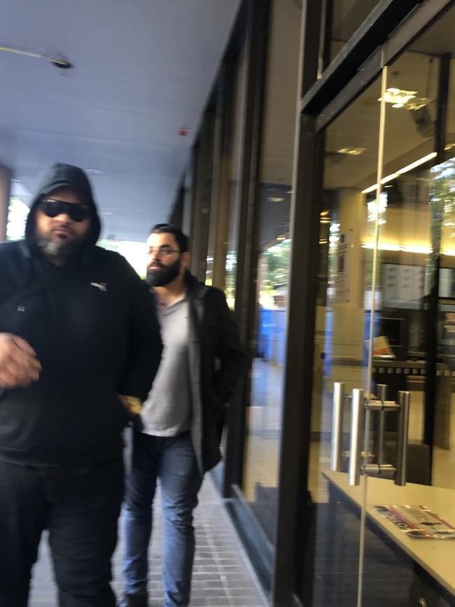 Mohammad Abdulmunim Saleh (right) leaves court after an earlier court appearance.