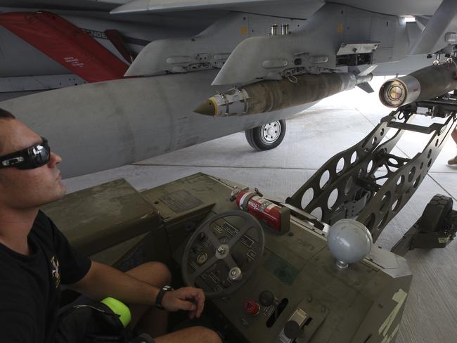 More weapons ... Royal Australian Air Force Armament Technicians load explosive ordnance onto a RAAF F/A-18F Super Hornet in the Middle East. Picture: Supplied