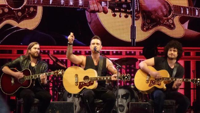 Language warning ... Robbie Williams with Tim Metcalfe and Flynn Francis, his Melbourne songwriting partners, performing Motherf-----. Picture: Melissa Reed TTM